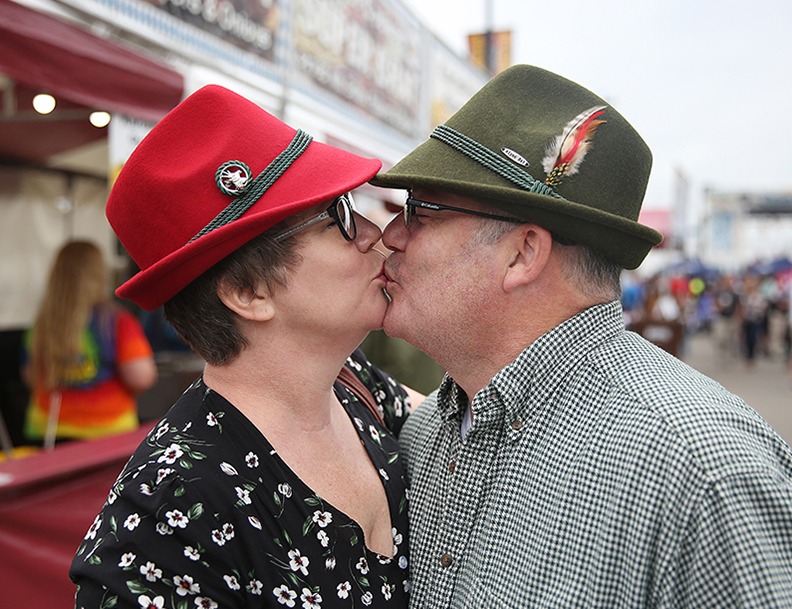 Daniel and Elizabeth Rademacher share a kiss at Oktoberfest Zinzinnati on Saturday, September 22, 2018.   Oktoberfest Zinzinnati showcases the rich German heritage of Southwest Ohio, as well as tasty samples of German-style music, food and beer. First held in 1976, the event has grown to be America's largest Oktoberfest with more than 575,000 people attending each year.  Oktoberfest Zinzinnati runs Friday through Sunday in downtown Cincinnati.