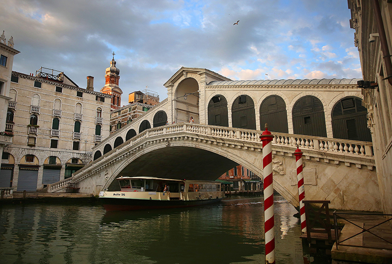 The Rialto Bridge in the Grand Canal in Venice, Italy.  Venice, the capital of northern Italy’s Veneto region, is built on more than 100 small islands in a lagoon in the Adriatic Sea. It has no roads, just canals – including the Grand Canal thoroughfare – lined with Renaissance and Gothic palaces.